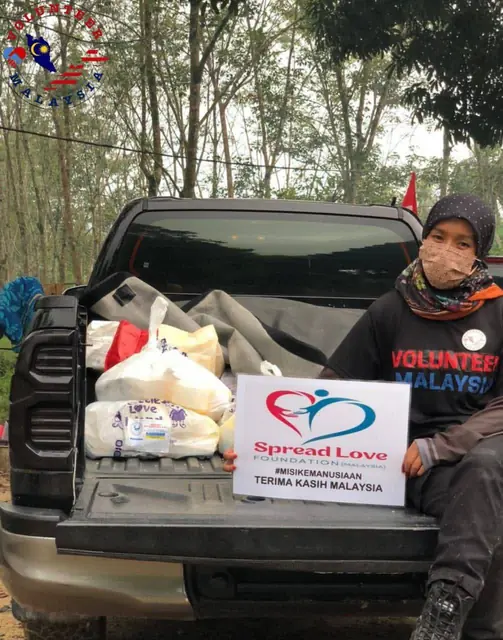 Volunteer with relief supplies in a truck