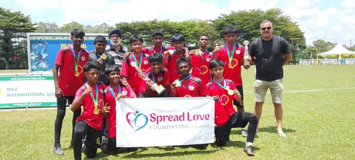 Football team with the Spread Love banner